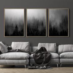 three black and white paintings in a living room