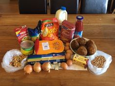 an assortment of food on a table with eggs, milk, nuts and other items