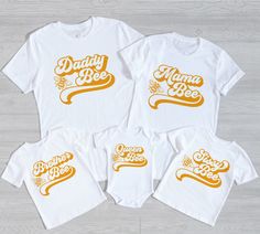 🍯🐝 The perfect tee for your little honey bee's birthday party 🍯🐝 *The font on the baby bodysuit/baby tee does not match the color of the mama shirt exactly - it's almost impossible to have an exact match - it's an orangey yellow* Our graphic tees are soft and versatile. They can be dressed up or down, styled with rolled sleeves, or tied in a knot to add some flair. SHIRT DETAILS -- 100% Soft cotton (fiber content may vary for different colors) -- Adult and Youth Shirts are Bella + Canvas, we Family Matching T-shirt With Letter Print For Family Events, Cute White T-shirt For Family Events, White Cute T-shirt For Family Events, White T-shirt With Text Print For Family Reunion, White Summer T-shirt For Family Events, Family Matching Letter Print T-shirt For First Birthday, Family Matching Custom Print T-shirt For First Birthday, Family Matching T-shirt For First Birthday, White Top For Mother's Day Family Events