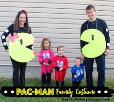 three adults and two children are dressed up as pac - man and the other family costume