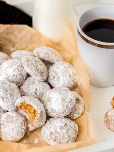 powdered doughnuts and coffee on a table