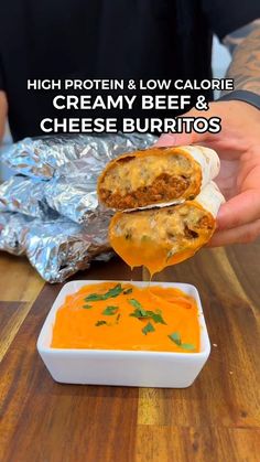 a person dipping cheese into a bowl of soup with the words high protein low calorie creamy beef and cheese burritos