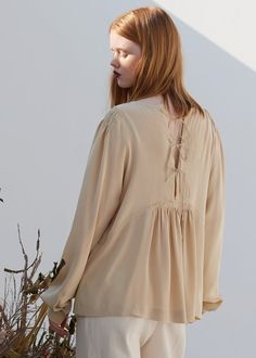 Description Elegant shirring on shoulder, sleeves and below chest Beautifully detailed with the back string tie and pearl buttons Material 100% Silk Made in South Korea Pearl Buttons, Cream Color, South Korea, Clothing Items, Bell Sleeve Top, Ruffle Blouse, Product Description, Silk, Cream