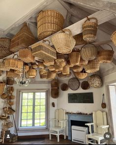 wicker baskets hanging from the ceiling in a living room