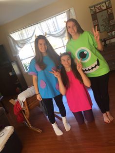 three girls are posing for the camera in front of a window wearing monster shirts and leggings