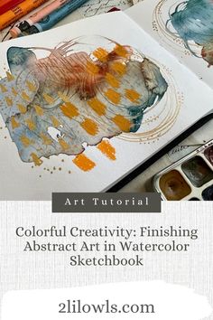 an art book with watercolors and pencils on it