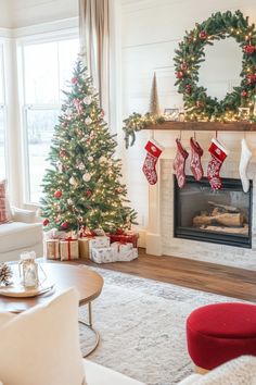 a living room filled with furniture and christmas decorations