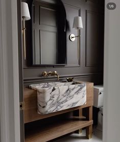 a bathroom with marble sink and vanity in it