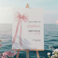 a welcome sign with a pink bow on it