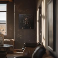 a living room filled with furniture and a painting on the wall next to a window