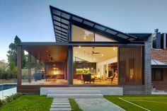 a modern house with grass and stairs leading up to it