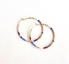 Large, hand-beaded boho-style hoop earrings. Very light weight.  4 beautiful color combinations to choose from. Made with very high quality Japanese beads. Gold plated, 1.5 inch hoops.  🌎 Packaging 🌎 To be environmentally responsible about packaging we will package orders together in the same box. If certain items in your order are intended as gifts and you'd like individual boxes, please leave a note during checkout. To view more items from this shop, click the link below:  https://www.etsy.c Package Orders, Seed Bead Hoop Earrings, Hoop Earrings Large, Bead Hoop Earrings, Japanese Beads, Beautiful Color Combinations, Large Hoop Earrings, Beaded Hoop Earrings, Beaded Hoops