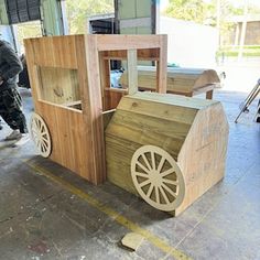 an old fashioned wooden cart with wheels in a garage