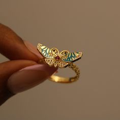 Embrace the enchantment of nature's beauty with our stunning Enchanted Butterfly Ring. Delicate enamel wings in a serene turquoise hue dance gracefully amidst 14k gold accents, while a radiant pink gemstone center adds a touch of springtime allure P R O D U C T ∙ M E A S U R E M E N T S * 100% 14k Solid Gold * Weight: 2.87g  *  Stone Diameter: 10mm/ 0.4 inch  * Band Width: 3mm/ 0.11 inch  Delivery:  * Ready to ship in 1 business day. * Delivers in 1 to 5 days depending on location and delivery option. * Returns are accepted within 7 days from the delivery date, at the customers cost. Gift Option: * We cherish the joy of gifting, as do you and your loved ones. Feel free to inform us if            you desire an additional personalized note with your order to make it an even more            s Diamond Enamel Ring With Gemstone For Gift, Elegant Hand Painted Ring Jewelry, Diamond Enamel Gemstone Ring Gift, Luxury 14k Gold Butterfly Ring As Gift, Unique Butterfly Ring For Wedding, Elegant Hand Painted Enamel Ring, Elegant 14k Gold Butterfly Ring Gift, Elegant Gemstone Butterfly Ring As Gift, Luxury Gemstone Butterfly Ring As Gift