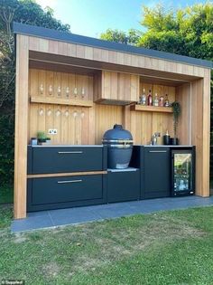 an outdoor bar is built into the side of a building with wooden paneling and shelves