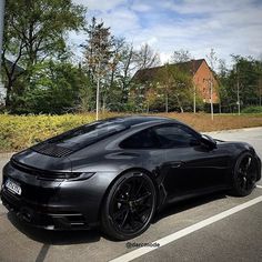 a black sports car parked in a parking lot