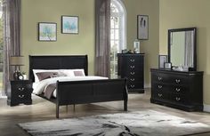 a bedroom scene with focus on the bed, dressers and mirror in the room