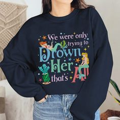 a woman wearing a sweatshirt that says we were only trying to drown her that's all