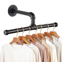 an image of clothes hanging on the rail with coat hangers in front of it