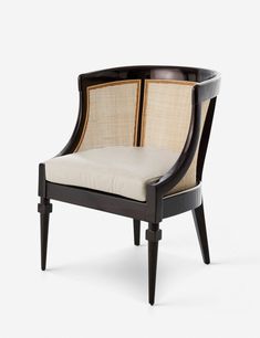 a black and white chair with beige upholstered cushions on the armrests