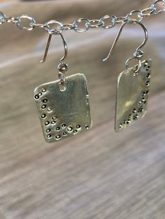 These earrings are shiny sterling silver w short square shape.  I have pounded dots into the silver and applied a black patina that filled in the dots so they are more visible.  They are versatile, could be worn for all occasions.  The ear wires are also sterling silver. Nickel-free Rectangular Sterling Silver Earrings, Silver Rectangular Everyday Earrings, Everyday Silver Rectangular Earrings, Silver Square Metal Earrings, Nickel-free Silver Square Pendant Earrings, Silver Square Everyday Earrings, Silver Sterling Silver Square Pendant Earrings, Square Sterling Silver Earrings, Everyday Silver Square Earrings