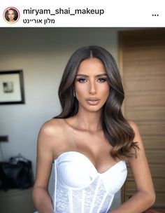 an image of a woman with long hair wearing a white corset and posing for the camera