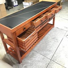 a large wooden table with drawers underneath it