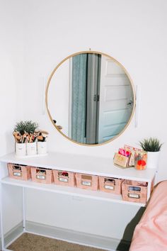 a white desk topped with drawers under a mirror