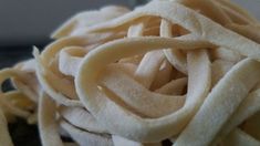 a pile of uncooked noodles sitting on top of a table