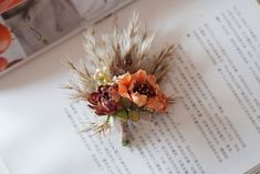 an arrangement of dried flowers sits on top of a book with chinese characters in the background