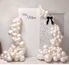 two white balloons shaped like the letter m