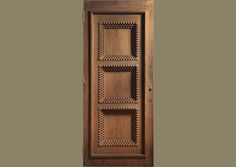 a wooden door with an intricate design on the front and side panels, which are made out of wood