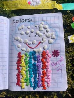 an open book with crochet rainbows and flowers on the pages is shown