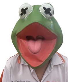 a person wearing a frog mask with his tongue out and eyes wide open, making a funny face