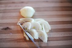 peeled bananas on a cutting board with a knife