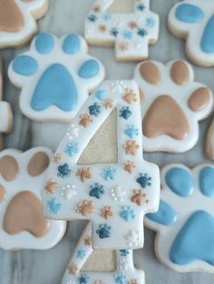 decorated cookies in the shape of numbers with paw prints