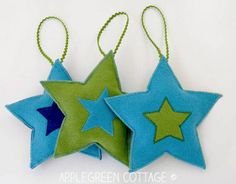 two blue and green stars hanging from strings