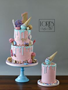 two cakes decorated with ice cream, sprinkles and candies