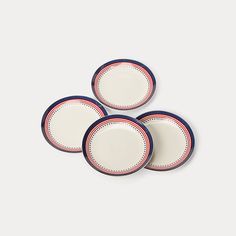 three white plates with red and blue trim