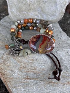 A very cool Desert Jasper cab  set in Sterling is the focal of this Earthy Bracelet.  The photos don't do it justice. It looks like the Desert Sky at Dusk.  I incorporated Green Rhyolite, Labradorite, Very cool Copper enameled Raku beads, Topaz Czech Glass and a plethora of Hill Tribe Silver.  I love the blend of muted desert colors! Hoodoos are a pewter Wild Rabbit and a Silver Leaf Jasper Zuni Bear. All give that Southwestern Cowgirl feel.   Leather loop can be adjusted for a tighter or looser fit. Hill Tribe Silver is made by the Hill Tribe people of Thailand. It is 99% pure Silver, as opposed to sterling silver which is 92.5%. Made by traditional methods, each piece is handmade, and is rolled and hammered with primitive tools. Primitive Tools, Desert Jasper, Wild Rabbit, Bracelets Ideas, Desert Colors, Desert Sky, Button Bracelet, Hill Tribe Silver, Chunky Bracelets