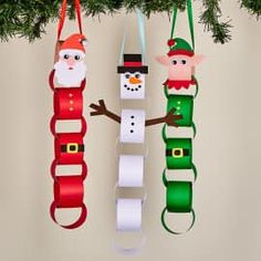 three christmas ornaments hanging from a tree with santa claus and snowman on them,