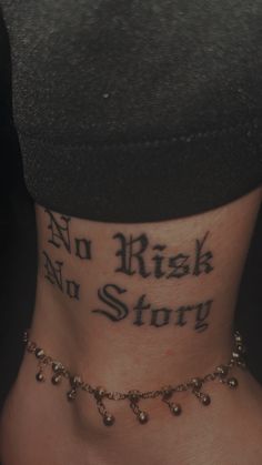 a woman's neck with the words, no risk and story tattooed on it