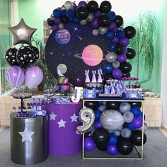 an assortment of balloons and decorations for a space themed birthday party with stars, planets, and more