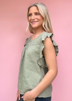 We adore simplicity and this summer top from Another Love is just that! Petal sleeve top, crew neck finished with front & back yoke & shirring, back keyhole. The Carefree urban expression of knowing & living you! Ruffle details the "down-to-earth" styling while enjoying all of life. Fit is true to size Olivia is 5'7 wearing small Size up of between sizes or for length Available in Xsmall - Large Cropped Length Not lined Pull on fit Fabric: 50% LINEN 47% RAYON 3% SPANDEX Machine wash cold, Tumble dry low Imported Body length from HPS: 24", Petal length: 1 3/4", Bust: 39" (Size Small) Green Flutter Sleeve Tops For Vacation, Spring Ruffled Scoop Neck Top, Scoop Neck Ruffled Tops For Spring, Green Casual Flutter Sleeve Top, Green Summer Tops For Casual Gatherings, Casual Green Top With Flutter Sleeves, Summer Green Casual Tops, Green Casual Summer Top, Casual Green Summer Top