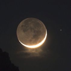 the moon and venus are visible in the night sky