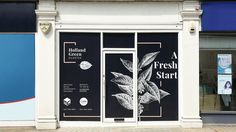 a store front with two large windows on each side and an advertisement for fresh start