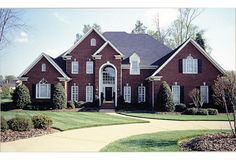 a large red brick house with white trim