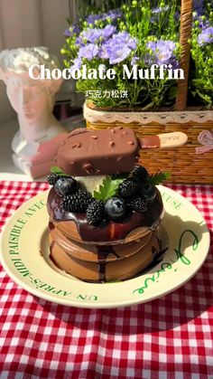 chocolate muffin with berries and cream filling sitting on a plate in front of flowers