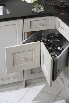 an open drawer in the middle of a kitchen