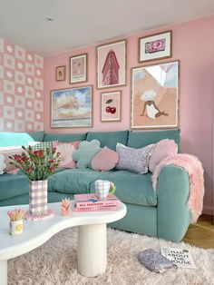 a living room with pink walls and blue couches in the center, white rugs on the floor